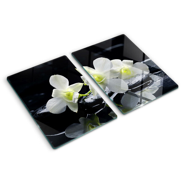 Glas schneidebrett Orchideen auf schwarzem Hintergrund