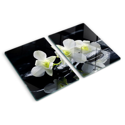 Glas-Schneidebrett mit Orchideenmotiv auf schwarzem Hintergrund