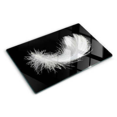 Schneidebrett Glas mit Motiv einer Feder auf schwarzem Hintergrund