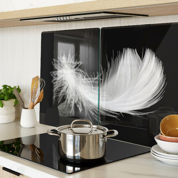 Schneidebrett glas Feder auf schwarzem Hintergrund