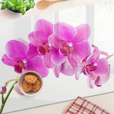 Glas-Schneidebrett mit Orchideen in Rosatönen