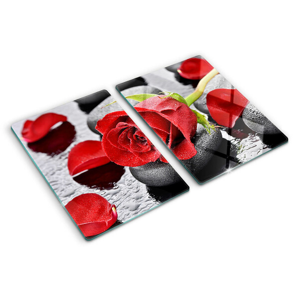 Glas-Schneidebrett mit Motiv einer Rose auf Steinen und Wassertropfen