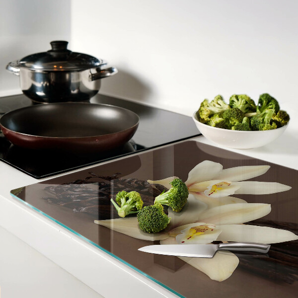 Glas-Schneidebrett mit Orchideen und Vanilleschoten als Motiv