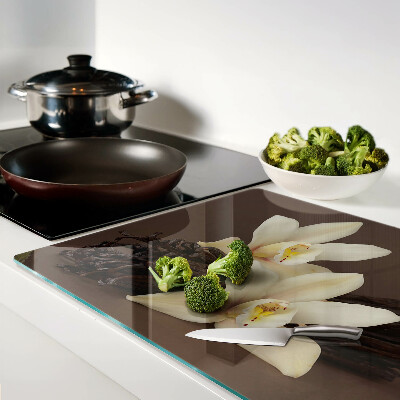 Glas-Schneidebrett mit Orchideen und Vanilleschoten als Motiv