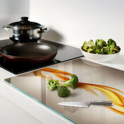 Schneidebrett Glas mit wellenförmigem Muster in Goldtönen