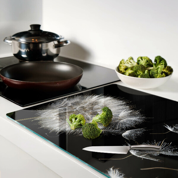 Schneidebrett Glas mit Löwenzahnmotiv auf schwarzem Hintergrund