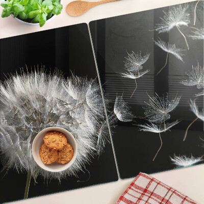 Schneidebrett Glas mit Löwenzahnmotiv auf schwarzem Hintergrund