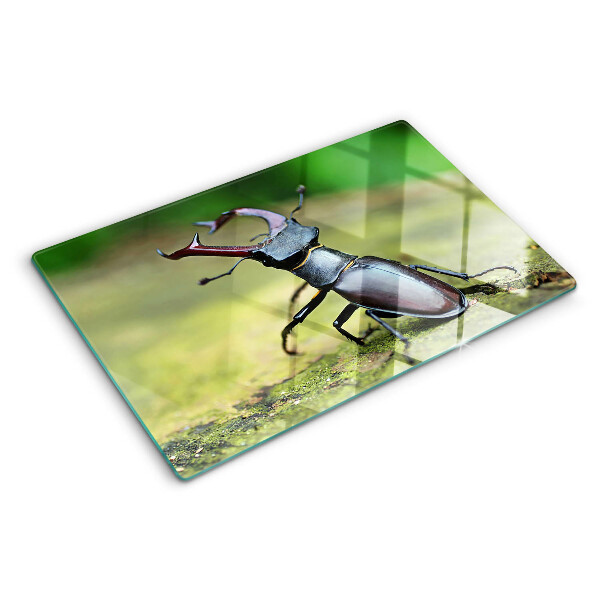 Schneidebrett Glas mit Hirschkäfer-Motiv auf grünem Hintergrund