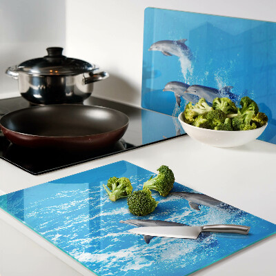 Schneidebrett Glas mit Motiv von Delfinen, die über Wellen springen