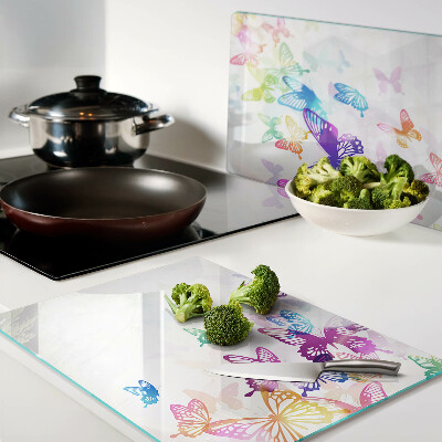 Glas-Schneidebrett mit einem Motiv aus bunten Schmetterlingen, die davonfliegen