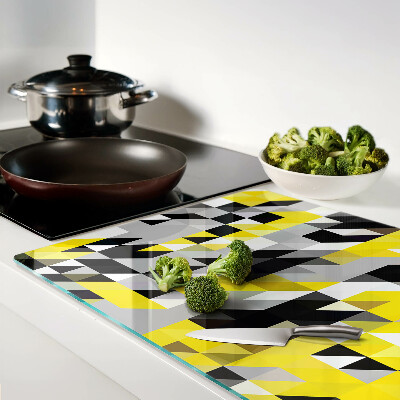 Glas-Schneidebrett mit geometrischem Muster in Gelb- und Schwarztönen