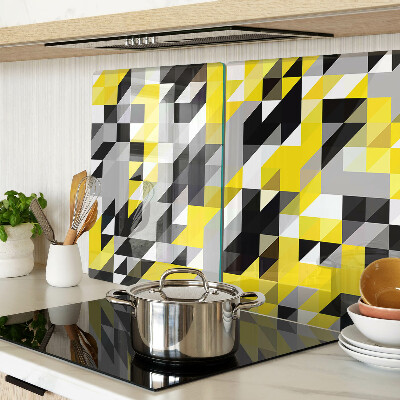 Glas-Schneidebrett mit geometrischem Muster in Gelb- und Schwarztönen