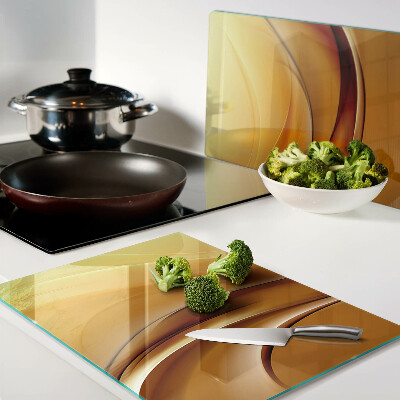 Glas Schneidebrett mit Wellen in Goldtönen