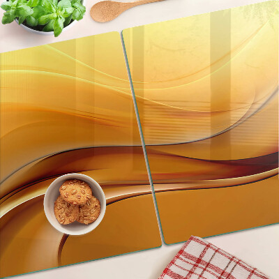 Glas Schneidebrett mit Wellen in Goldtönen
