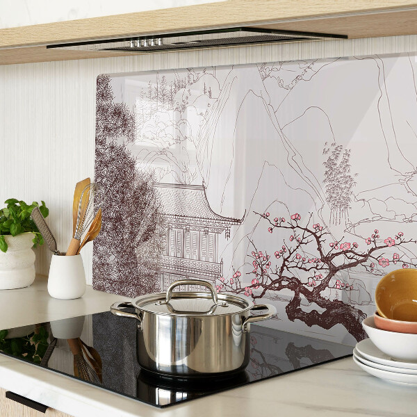 Glas-Schneidebrett mit einer Berglandschaft und blühenden Bäumen