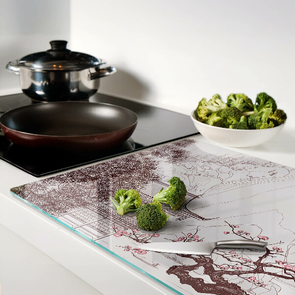 Glas-Schneidebrett mit einer Berglandschaft und blühenden Bäumen