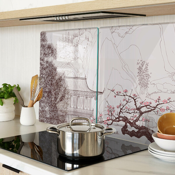 Glas-Schneidebrett mit einer Berglandschaft und blühenden Bäumen