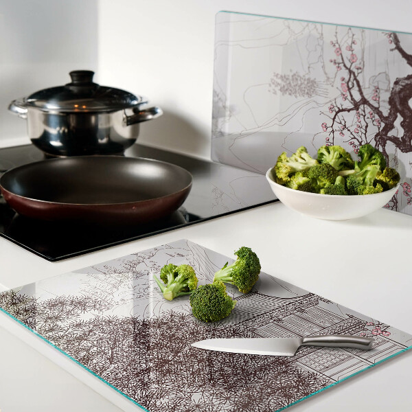 Glas-Schneidebrett mit einer Berglandschaft und blühenden Bäumen