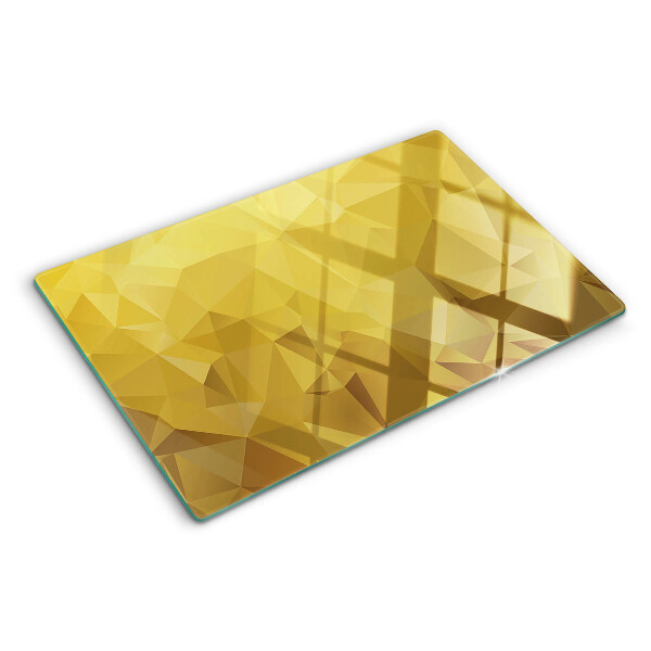 Glas-Schneidebrett mit geometrischem Muster in Goldtönen