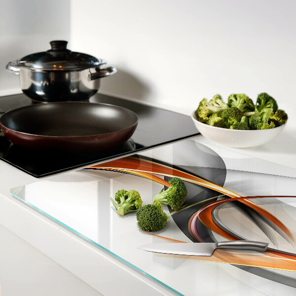 Schneidebrett Glas mit abstraktem Wellenmuster in Goldtönen