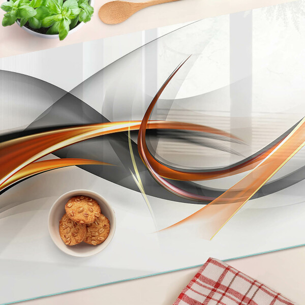 Schneidebrett Glas mit abstraktem Wellenmuster in Goldtönen