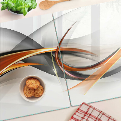 Schneidebrett Glas mit abstraktem Wellenmuster in Goldtönen