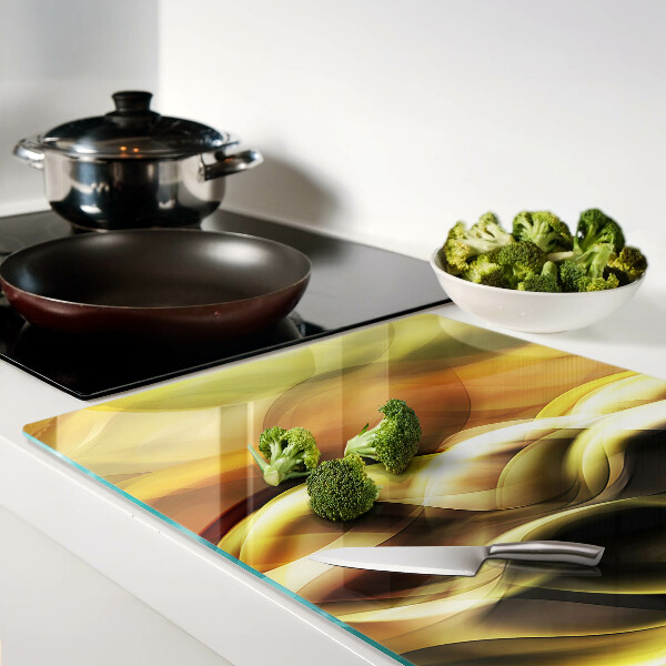 Schneidebrett Glas mit abstrakten Wellen in Goldtönen