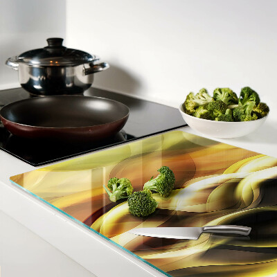 Schneidebrett Glas mit abstrakten Wellen in Goldtönen