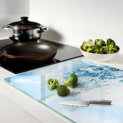 Glas schneidebrett Löwenzahnblüte mit Wassertropfen