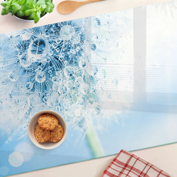 Glas schneidebrett Löwenzahnblüte mit Wassertropfen