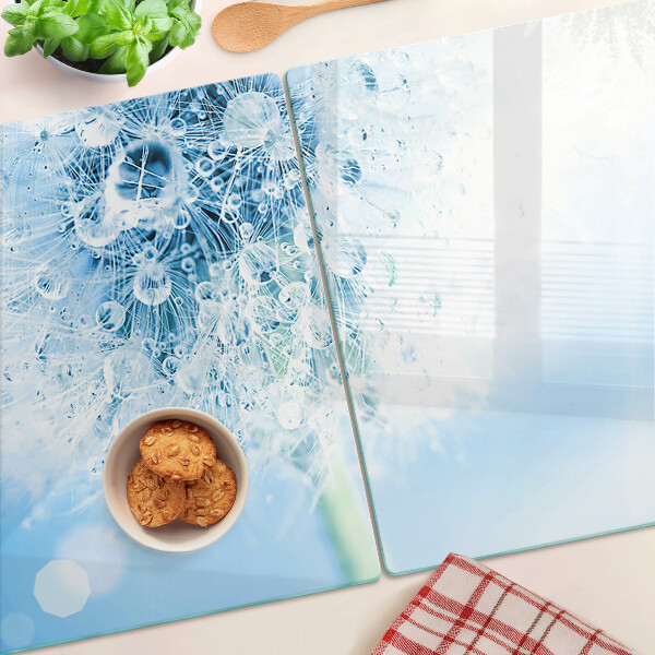 Glas schneidebrett Löwenzahnblüte mit Wassertropfen