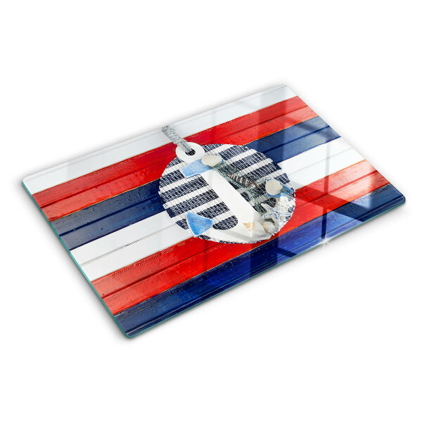Glas Schneidebrett mit Anker-Motiv vor gestreiftem Hintergrund
