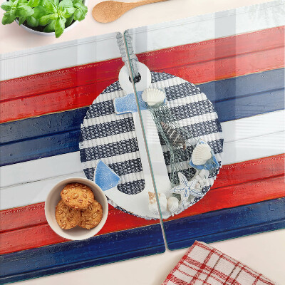 Glas Schneidebrett mit Anker-Motiv vor gestreiftem Hintergrund