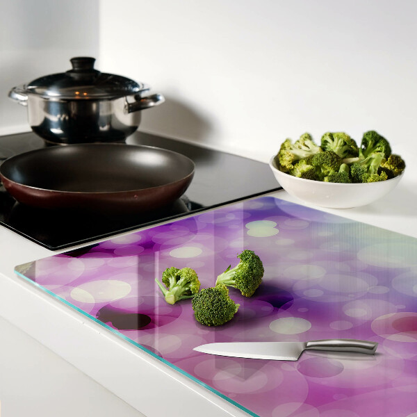 Glas-Schneidebrett mit Bokeh-Motiv in Lila- und Rosatönen