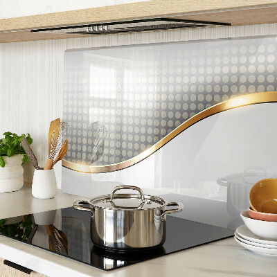 Schneidebrett Glas mit einem goldenen Wellenmotiv auf gepunktetem Hintergrund