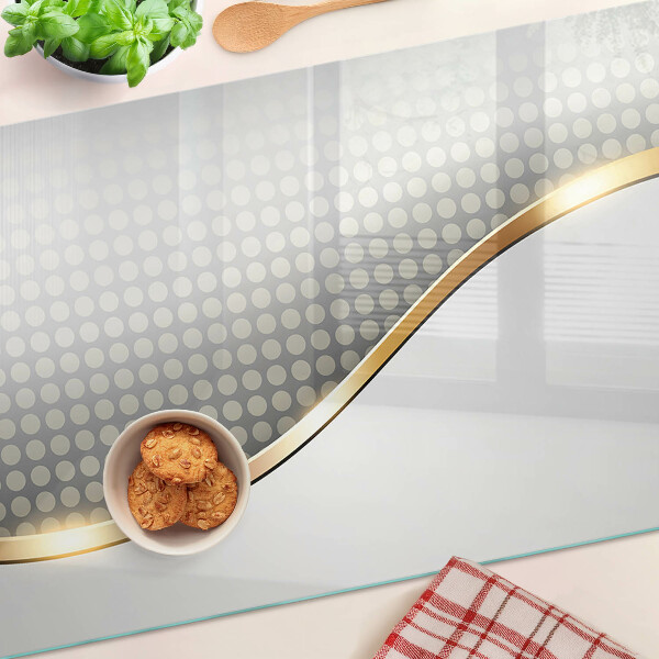 Schneidebrett Glas mit einem goldenen Wellenmotiv auf gepunktetem Hintergrund