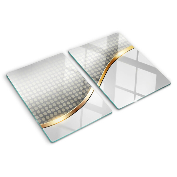 Schneidebrett Glas mit einem goldenen Wellenmotiv auf gepunktetem Hintergrund