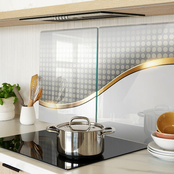 Schneidebrett Glas mit einem goldenen Wellenmotiv auf gepunktetem Hintergrund