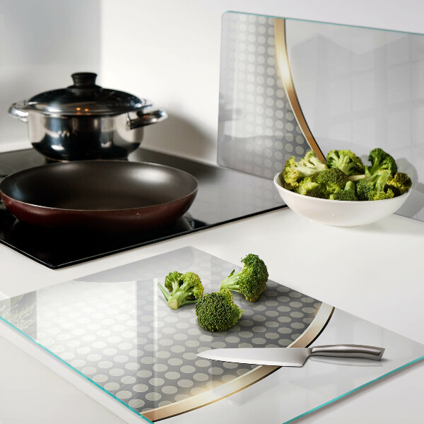 Schneidebrett glas Eine goldene Welle auf einem Hintergrund aus Punkten