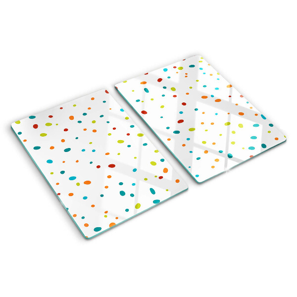 Glas-Schneidebrett mit bunten Punkten auf weißem Hintergrund