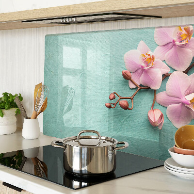 Glas Schneidebrett mit Orchideenmotiv auf blauem Hintergrund