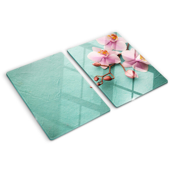 Glas schneidebrett Orchideen auf blauem Hintergrund