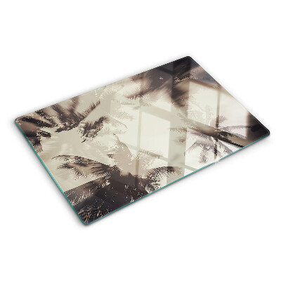 Schneidebrett mit Palmenmotiv auf einfarbigem Hintergrund