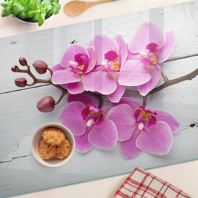 Schneidebrett Glas mit Orchideenmotiv auf weißem Hintergrund
