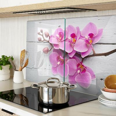 Schneidebrett Glas mit Orchideenmotiv auf weißem Hintergrund