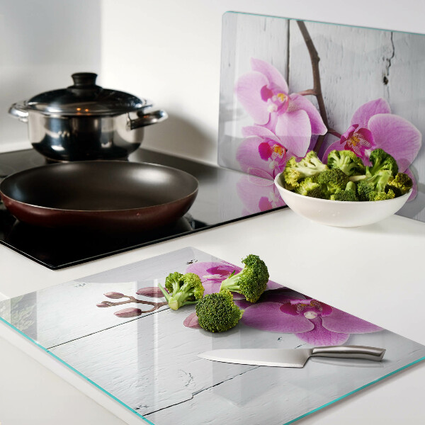 Schneidebrett Glas mit Orchideenmotiv auf weißem Hintergrund