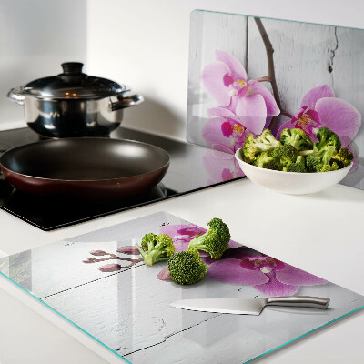 Schneidebrett Glas mit Orchideenmotiv auf weißem Hintergrund