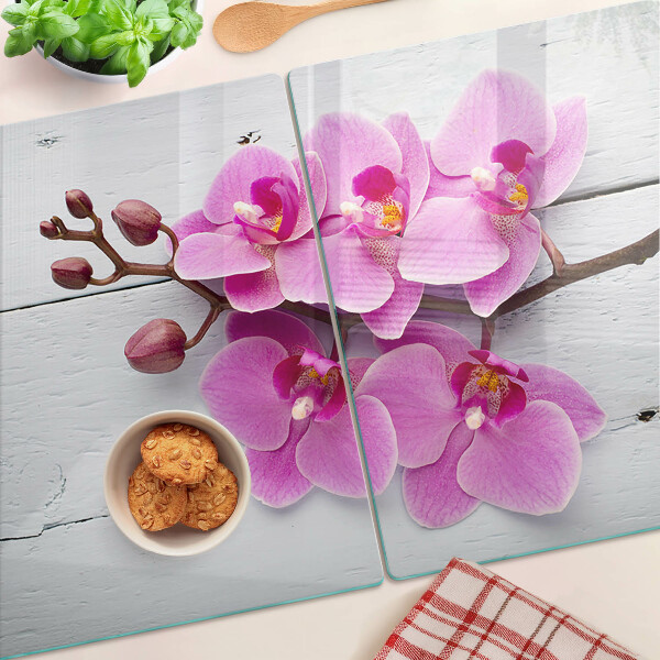Schneidebrett Glas mit Orchideenmotiv auf weißem Hintergrund