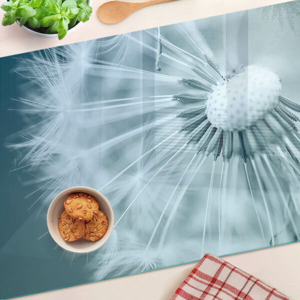 Glas schneidebrett Löwenzahn vor dem Himmel