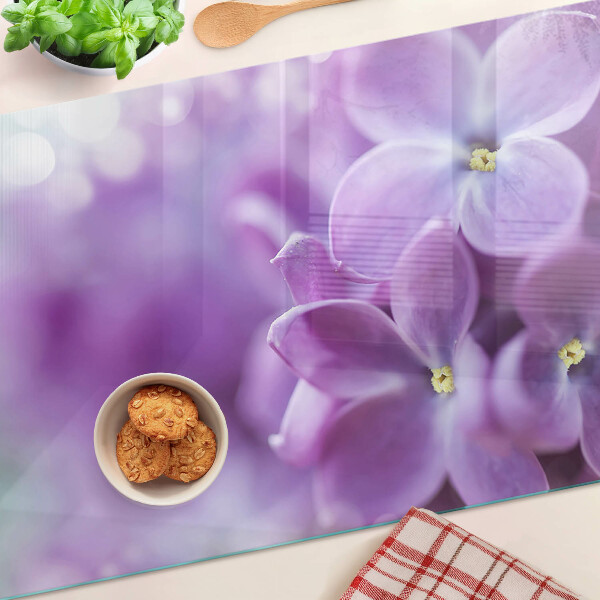 Schneidebrett Glas mit Blumen in Lilatönen